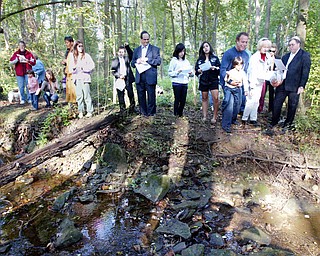 Re-enacting Tashlich on Rosh Hashana, Rabbi Joseph Schonberger and members and friends of Temple El Emeth tossed bread into a stream flowing through a ravine near the rabbi’s home Tuesday afternoon.