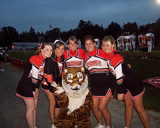Springfield Senior Cheerleaders Ally Anglin, Courtney Gobel, Kelli Kampfer, Laura Krcelic, Jordan Peshek, and Mascot Heather Cozak, cheer the Tigers to victory at the Columbiana game.