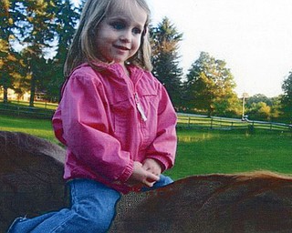 Ava Stankovich, 3, from Columbus, loved her first ride on a horse while visiting her grandmother, Eileen, in Youngstown. Photo submitted by Mary Sigel, friend of the family.
