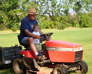 Our summer fun, Andrew Morgan, 2, helping "Papa" Jim Hickok of Canfield.
