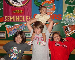 Alec Carson(Tampa, Fl) Stefan Russell with Adriana Trafficante on shoulders
and Olivia Russell ( all of Boardman, OH) on a visit to tampa, Fla. Picture
taken by John Trafficante.
