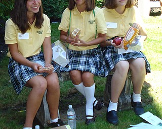 From: Linda Miller
August Days at Ursuline High School! Freshmen Olivia Murphy, Taylor Daly, and Lindsay Pratt enjoy a picnic lunch in the Meditation Garden of the Ursuline High School Campus in Youngstown. These friends met at the August 18 Freshman Orientation Day.