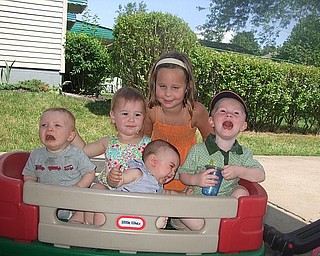 Wagon pain: From left, boys in front, Ryan Bassetti, Anthony Bassetti (tilted) and Andrew Bassetti have various reactions to sitting in a Little Tikes wagon in driveway during family visit. In back middle, from left, girls are Meredith Ashbaugh and Olivia Ashbaugh. The cousins are from Columbus, California and Pittsburgh.
