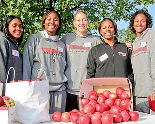 HELPING HANDS: Monique Godfrey, Ashley Pendleton, Rachel Manuel, coach Deidre Jones of Boardman and Tiara Scott of the women's basketball team came to help hand out snacks and T-shirts during Saturday's Coaches vs. Cancer 3-mile walk at Youngstown State University.