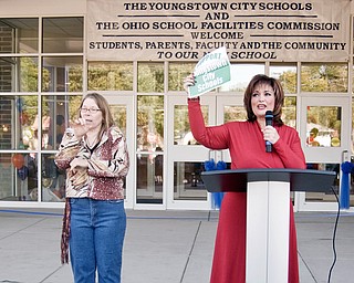 SHOWING SUPPORT: An interpreter, (left), signs to the crowd as Paul C. Bunn Principal Maria Pappas, (right), gives her speech during Sunday afternoon’s ribbon cutting for the new elementary school. Pappas discussed a push to increase public support for a school levy that will appear on the ballot in November.