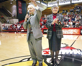 Former YSU basketball coach Don Rosselli speaks to the crowd gathered at Beeghly Stadium while being honored. Don's wife of 62 years, Connie, stands by his side in center court.