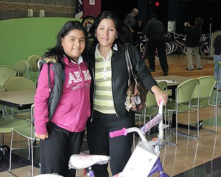 Loren Roldan is proudly standing with her 9yr old daughter, Bethzaida. Her daughter is one of 62 4th graders that got a free bike for passing all three parts of the 4th grade's OAT.