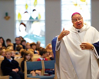 Bishop George Murry delivers a Homily during a mass at Holy Family in Poland Wednesday.