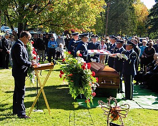 SOMBER SERVICE: Bill Cross, left, brother of Air Force Capt. James Cross, speaks at his brother's funeral with full military honors at Crown Burial Park in Vienna. The remains of the Warren man were buried there Friday. Cross show down over Laos in April 1970.