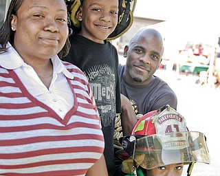 From left to right at top, Alisha, Malik, 6, and Antwon Pierece, below, Tyree, 7, Pierece attended the free Fall festival on Saturday at Idaho Road Church in Austintown.