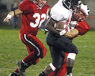 CANFIELD - NILES - (32) Alan Koren Jr. and (33) Nico Wagner bring down (14) Blake Jackson of Canfield during their game Thursday night in Niles.