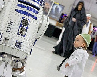 Nathaniel Slivkoff (14 months) of Niles hangs out with R2D2 at the Screaming Tiki Comic and Pop Culture Convention. Hopefully Darth Sidius (in background) doesn't get Nathaniel to join the dark side!