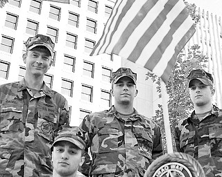 L-R UT1 Richard Gaskill, BUCA Alfonso Sierra III, BU3 Travis Ware and CECN Kevin Miller stand at attention after completing their memorial to several wars in the downtown square. Saturday October 19, 2008. Daniel C. Britt.