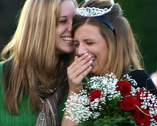 "Last year's homecoming queen, Ashley Neimi, and this year's
homecoming queen, Chelsie Leeson, share a moment during the crowning
ceremony."