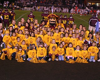 "South Range Cheerleaders held an Elementary Cheer Camp last week.
The Elementary cheerleaders pose with the Raider Mascot during their
performance during the game Friday night."