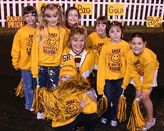 "Varsity Cheerleader Tizzy Baytos poses with several of her 3rd grade
cheerleaders Friday night."