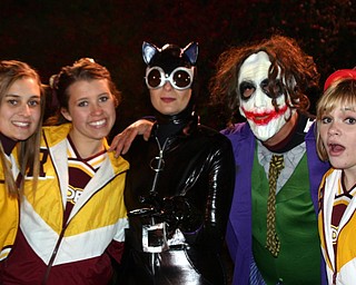 "The Joker and Catwoman paid a visit during the South Range band show
Friday night and requested a picture with cheerleaders Cheyenne Sears,
Jesse Heck, and Tizzy Baytos."