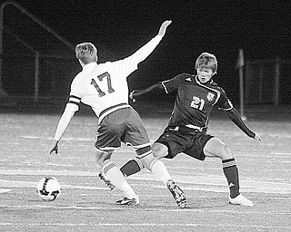 CANFIELD - GLENOAK - (21) Nate Merhaut of Canfield tries to stop (17) Spencer Semple during their game Wednesday night.