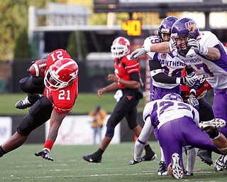 YSU Penguin Dana Brown (21) is captured in the air after he escapes a dog pile.