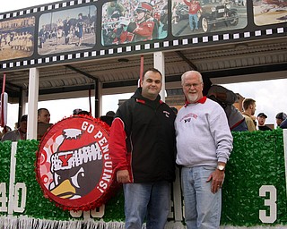 John Young and John Young! Father and son, are both alumni of YSU are standing in front of the Sigma Chi float that the son made.