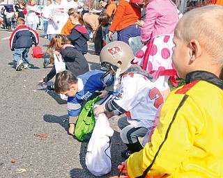 James Edison (3) on far right and many other children collect pieces of candy thrown to them at the parade in Niles Sunday October 26, 2008