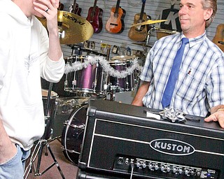 15 year old Gage Markley, left, of Champion gets another surprise. Frank Fordeley gives Gage the Kustom amplifier for beating leukemia.
