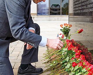 George Otto, service officer for the American Legion who specializes in Veterans Mental Health, lays a rose for a local soldier killed or missing-in-action in the Vietnam War at the VIetnam War Memorial in the Federal Plaza Sunday, November 2, 2008. Daniel C. Britt.
