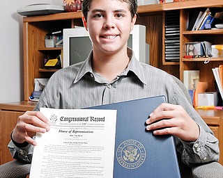 Brock DeAngelo holds up a copy of the "Congressional Record" of the Childen's Bill of Rights"