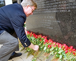 Barry Landgraver, Executive Director of the Veterans Service Commission lays a rose for a local soldier killed or missing-in-action in the Vietnam War at the VIetnam War Memorial in the Federal Plaza Sunday, November 2, 2008. Daniel C. Britt.