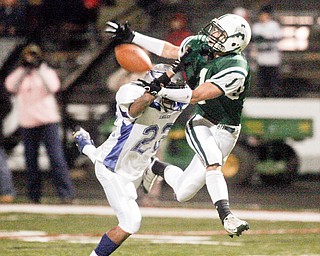 BREAKING UP A PASS - Hubbards Chase Myers (22) gets in the way of Aurora's Mike Ganoe (1) during first half action at Mollenkompf Stadium in Warren. Officials ruled pass interference.