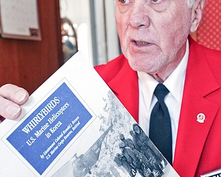 READ ALL ABOUT IT: Marine veteran Richard Mitchells Sr. shows a book about the helicopters on which he was an aircraft electrician.