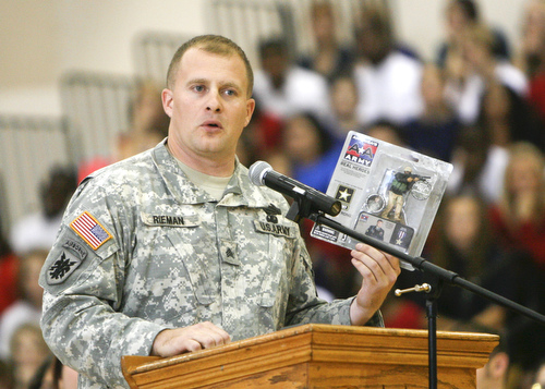 Tommy Rieman, who received a Purple Heart medal after getting shot up in Iraq. speaks to Liberty students at the Veterans Day Ceremony- he told about his experience in Iraq - and of being in a recruiting video as well as an Action figure
