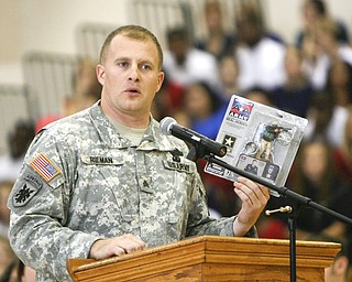 Tommy Rieman, who received a Purple Heart medal after getting shot up in Iraq. speaks to Liberty students at the Veterans Day Ceremony- he told about his experience in Iraq - and of being in a recruiting video as well as an Action figure