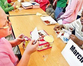 Girard Intermediate School 4th graders Becca Deal, left, and Khadejah Davidson during mix it up day lunch program. Students sat with students with same month birthdays.