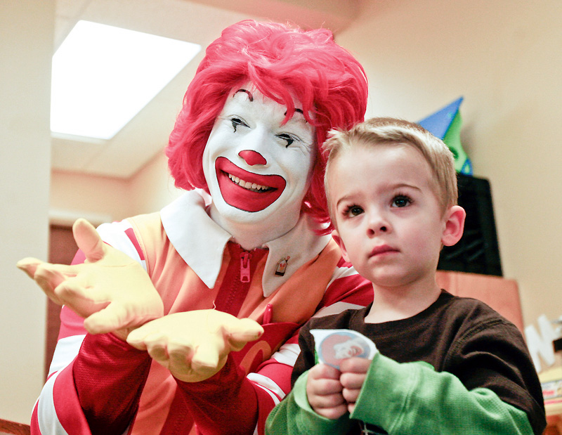SMILE: Iconic fast-food character Ronald McDonald shares a moment with Len Finsen at the Children's Rehabilitation Center in Howland. Ronald stopped Monday at the center with his pals, the owners of McDonald's restaurants in the Mahoning Valley, to raise awareness about fundraising efforts.