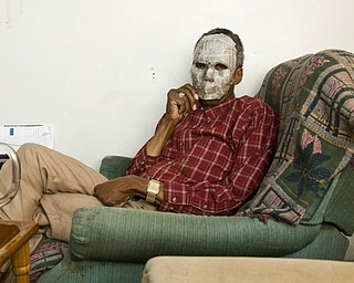 Wilbur, a straight, black male with HIV in Youngstown, reclines in his living room. His face is covered with a Halloween mask to hide his identity. Although he said he hasn't experienced much discrimination, he is careful about disclosing. "Years ago, a friend of our family had cancer. When we went over there, we were told to cover the toilet seat. That's how HIV is perceived now," he said.