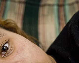 Georgia poses in the game room of a house sponsored by the Ursuline Sisters AIDS Ministry for children infected or affected by HIV/AIDS.  The house offers meals, counseling and academic help to Georgia and 25 other kids who have the disease or live with someone who does.  She has been visiting several times a week basis since age 6, when her mother was diagnosed with HIV, and is comfortable enough to arrive in her pajamas.  
Though the feeling of isolation attached to caring for a family member with HIV solidified for Georgia and her older brother almost a decade ago, she has still only one friend outside of the house who knows her mom is infected.   
Daily worry about her mother dying coupled with the fear of being mocked by other kids has closed her off, she said.
"They don't know what its like. The girls and make fun you for the stupidest things," Georgia said. "I'm used to being quiet at school. When I'm here [at the house], I can express myself."