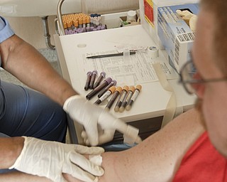 A nurse at an HIV/AIDS clinic takes weekly blood samples from Michael Bushara, a gay, white male in Youngstown. Medical check-ups and the pill regiment divide the day, Michael said.
