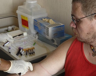 A nurse at an HIV/AIDS clinic takes weekly blood samples from Michael Bushara, a gay, white male in Youngstown. Medical check-ups and the pill regiment divide the day, Michael said.