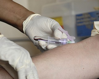 A nurse at an HIV/AIDS clinic takes weekly blood samples from Michael Bushara, a gay, white male in Youngstown. Medical check-ups and the pill regiment divide the day, Michael said.