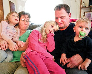 Tabitha Fiorenza, 7, center, heart recipient with family sister Hayley, 5, mom Lori, dad Mike and brother Alex, 13 months in their Struthers home.