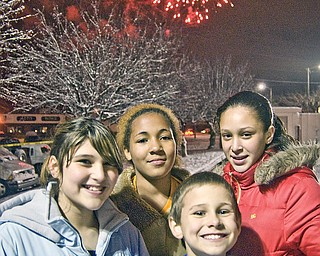 Clockwise from left, Sharonites Alex Cicone, 12, Niyahsa Justice, 12, Laquanda Teague, 13 and Tristen Delgross, 9, turn from the fireworks just long enough to pose for a picture. Light-up Sharon, West State Street downtown.
