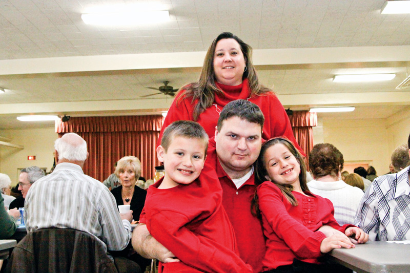 Heather Kutsch in back with her family, L-R Hunter (9), Mike and Maddison (7) at Girard First United Methodist Church for a spaghetti dinner benefit for Mike Kutsch who was diagnosed with Huntington's Disease 8 years ago Sunday.