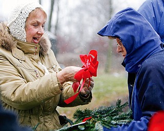 Fixing bows on the wreaths Barbara Delisio of Poland and Doris Purner both part of the Master Gardners programs affix bows to the wreaths as 27 Christmas wreaths were placed on the gravestones of 27 veterans in Zion Lutheran Cemetery  in Boardman to honor those who gave their lives while serving in the armed forces.