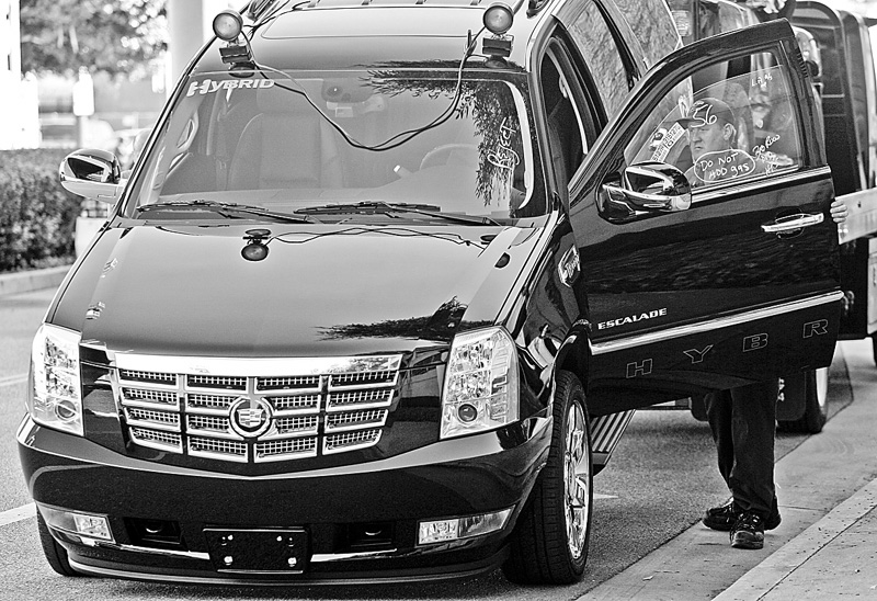 A driver prepares to unload a new 2009 Cadillac Escalade 2WD Hybrid, onto the floor of the Los Angeles Convention Center, for the Los Angeles Auto Show  Tuesday, Nov. 18, 2008. New cars are supposed to be the main attraction when the Los Angeles Auto Show kicks off, but dreadful U.S. sales, bailout hearings in Congress, and General Motors' decision to all but pull out of the event are sure to be the elephants on the showroom floor. 