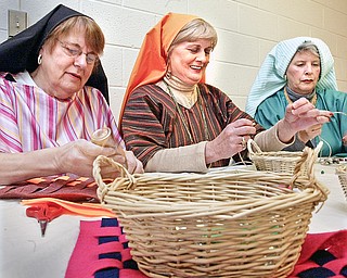 Churchill United Methodist Church in Liberty will host a Night in Bethleham. Dressed in period attire these members of the church L-R Pat Marsh, Marlene Flickinger and Jan Ferry prepare craft items for the event.