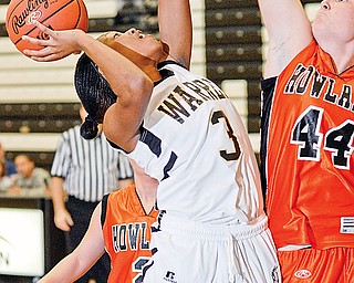 Harding's Ronisha Howard (3) tries to shoot over Howland's Kelly Barzak (44) during their game at Harding on Friday night.