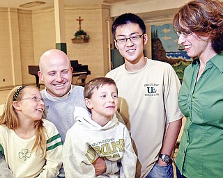 Ursuline football coach Dan Reardon with his children Emma and Matthew, wife Amanda and exchange student John Dong from Bejing who is staying with the Reardons.