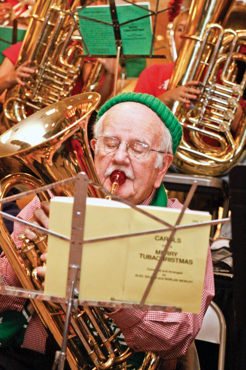 Ted O'Connor (84) of Youngstown is the eldest tuba player at Tuba Christmas in the main concourse of Eastwood Mall in Niles, Saturday.