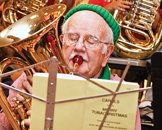 Ted O'Connor (84) of Youngstown is the eldest tuba player at Tuba Christmas in the main concourse of Eastwood Mall in Niles, Saturday.